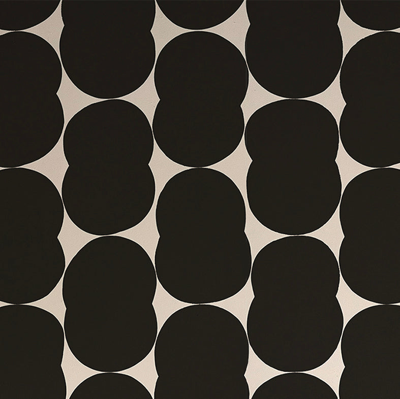 Detail of wallpaper in an abstract curvilinear pattern in black on a white field.