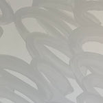 Detail of wallpaper in an abstract paintstroke print in gray on a light gray field.