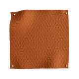 Wool trellis jacquard swatch pinned in all corners in warm orange