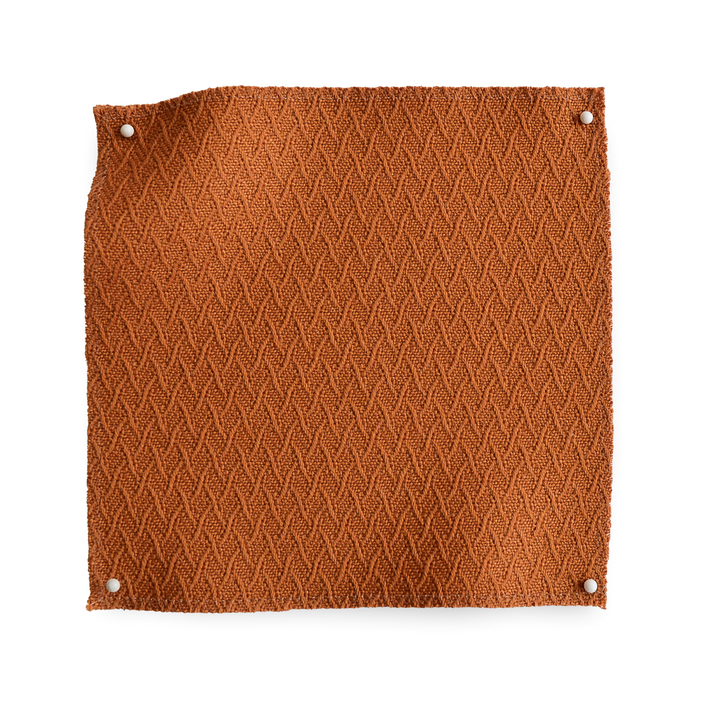 Wool trellis jacquard swatch pinned in all corners in warm orange