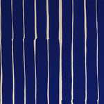 Detail of wallpaper in a playful irregular stripe print in cream on a navy field.