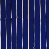 Detail of wallpaper in a playful irregular stripe print in cream on a navy field.