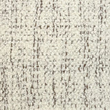 Broadloom carpet in cream bouclé with brown accents. 