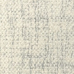 Broadloom carpet in cream bouclé with grey accents. 