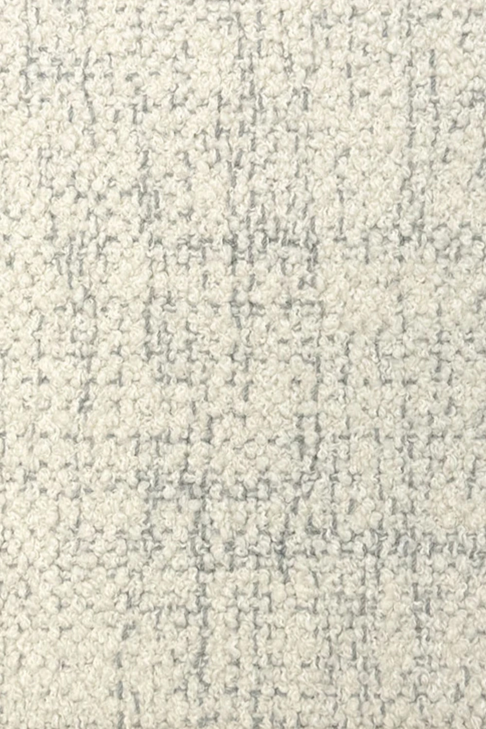 Broadloom carpet in cream bouclé with grey accents. 