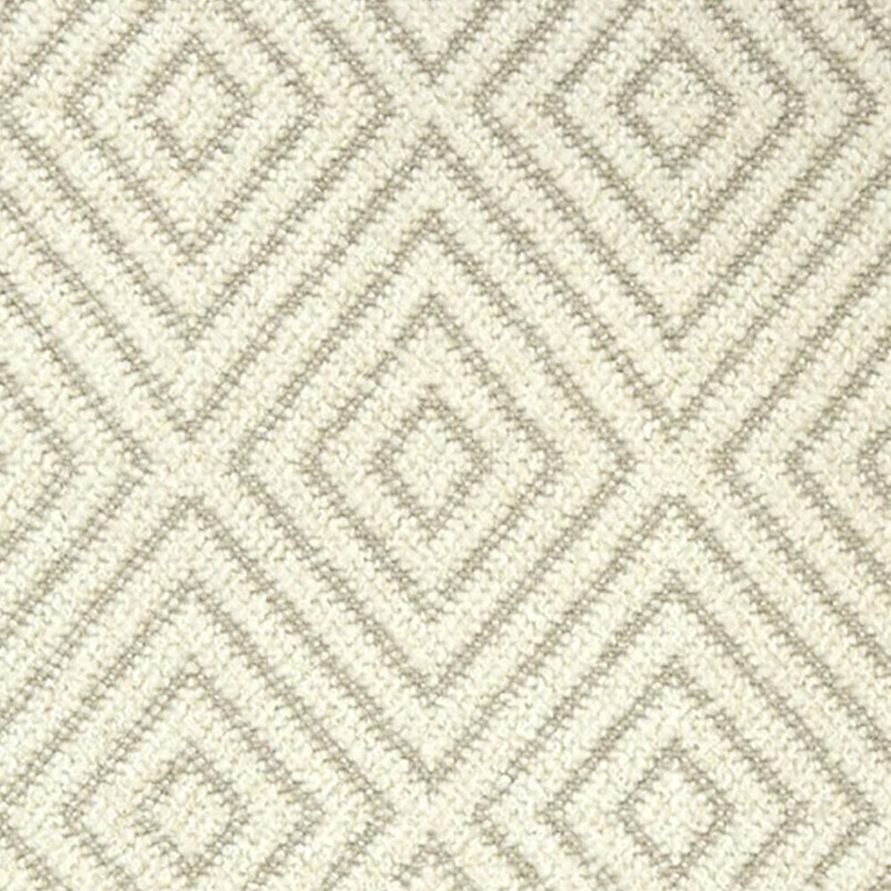 Broadloom carpet with dimensional diamond pattern in cream with beige. 
