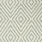 Broadloom carpet with dimensional diamond pattern in cream with grey.