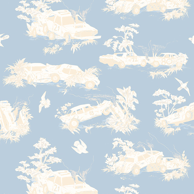 Detail of wallpaper in a playful illustrated car crash print in cream and white on a light blue field.