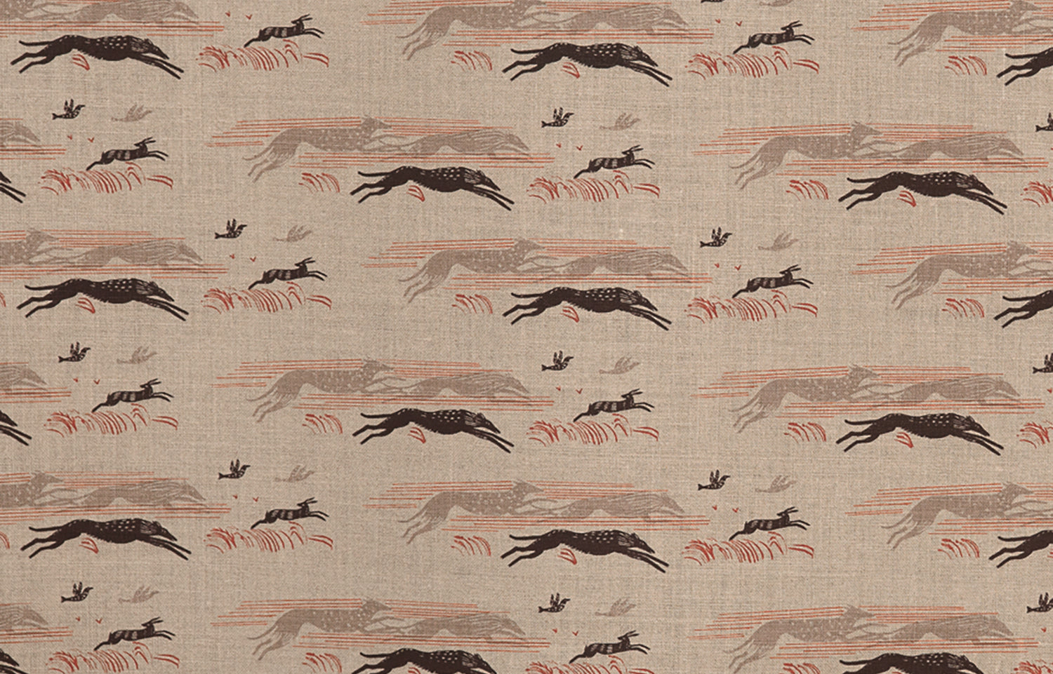Detail of fabric in a running whippet print in shades of brown, red and gray on a tan field.