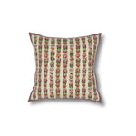 Throw pillow with printed and embroidered floral stripe design in orange and fuchsia with green accents on a white field. 