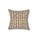 Throw pillow with printed and embroidered floral stripe design in orange and fuchsia with green accents on a white field. 