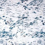 Detail of fabric in a painterly seaside print in shades of blue and gray on a white field.