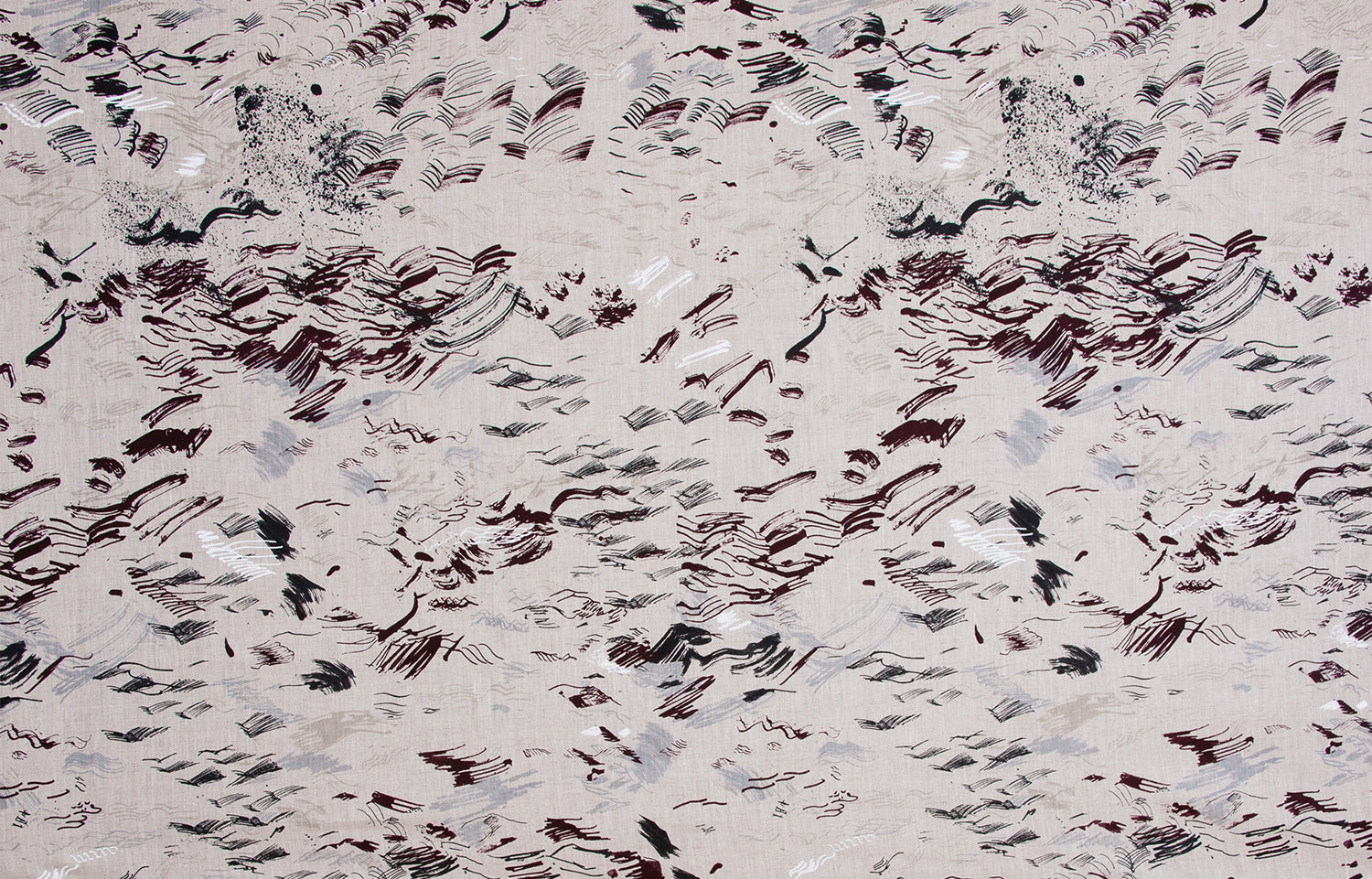 Detail of fabric in a painterly seaside print in shades of gray and maroon on a tan field.