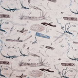 Detail of fabric in a painterly tree branch print in shades of brown and blue on a tan field.