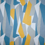 Detail of fabric in an abstract geometric print in blue, gray, yellow and white.