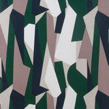 Detail of fabric in an abstract geometric print in blue, green, white and tan.
