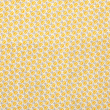 Detail of fabric in a dense geometric print in yellow, gray and cream.