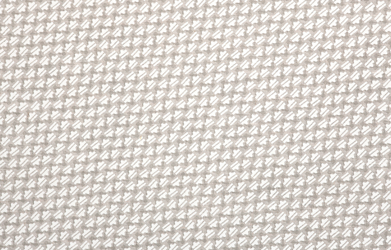 Detail of fabric in a dense geometric print in gray, white and cream.