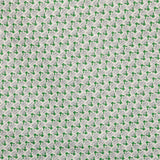 Detail of fabric in a dense geometric print in gray, green and cream.