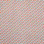 Detail of fabric in a dense geometric print in red, blue and cream.