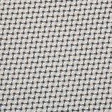 Detail of fabric in a dense geometric print in black, white and cream.