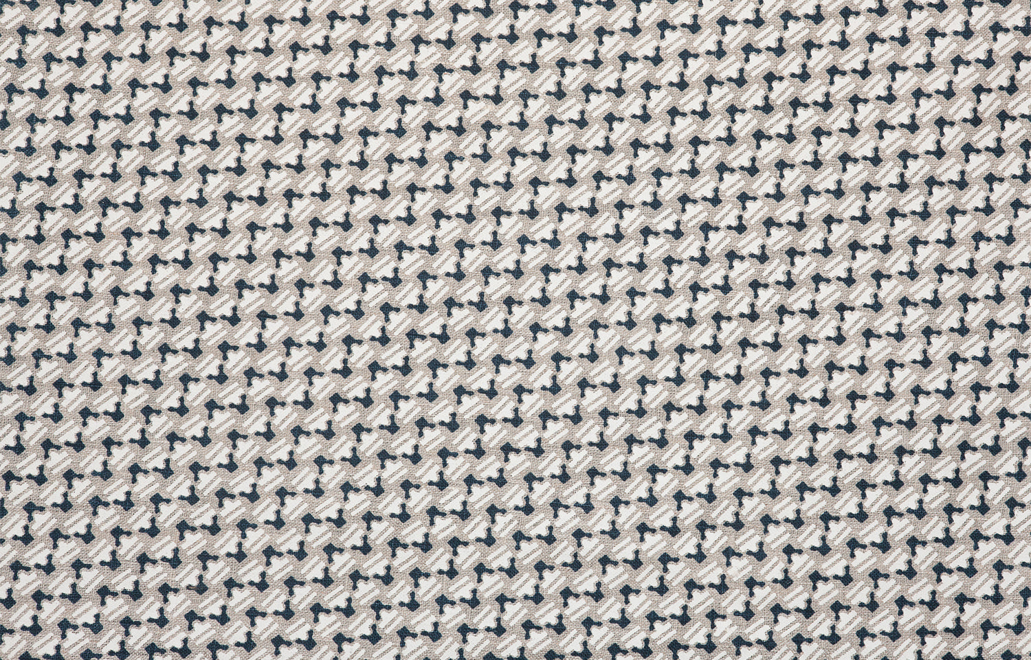 Detail of fabric in a dense geometric print in black, white and cream.