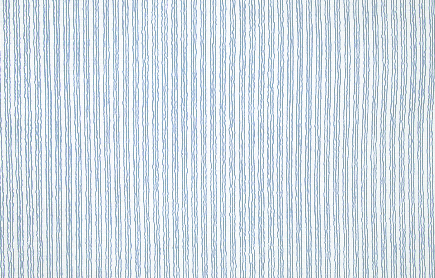 Detail of fabric in a wiggly stripe print in blue on a white field.