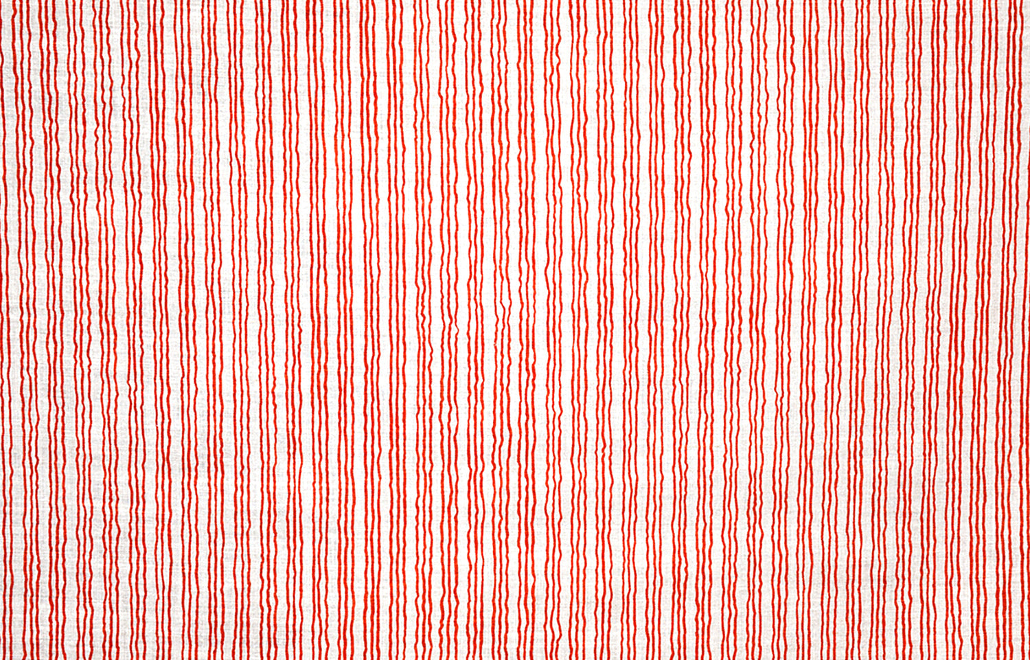 Detail of fabric in a wiggly stripe print in red on a white field.
