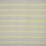 Detail of fabric in a horizontal striped print in yellow and white on a tan field.