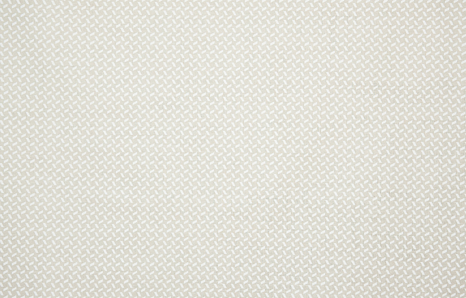 Detail of fabric in a small-scale geometric grid print in white on a cream field.