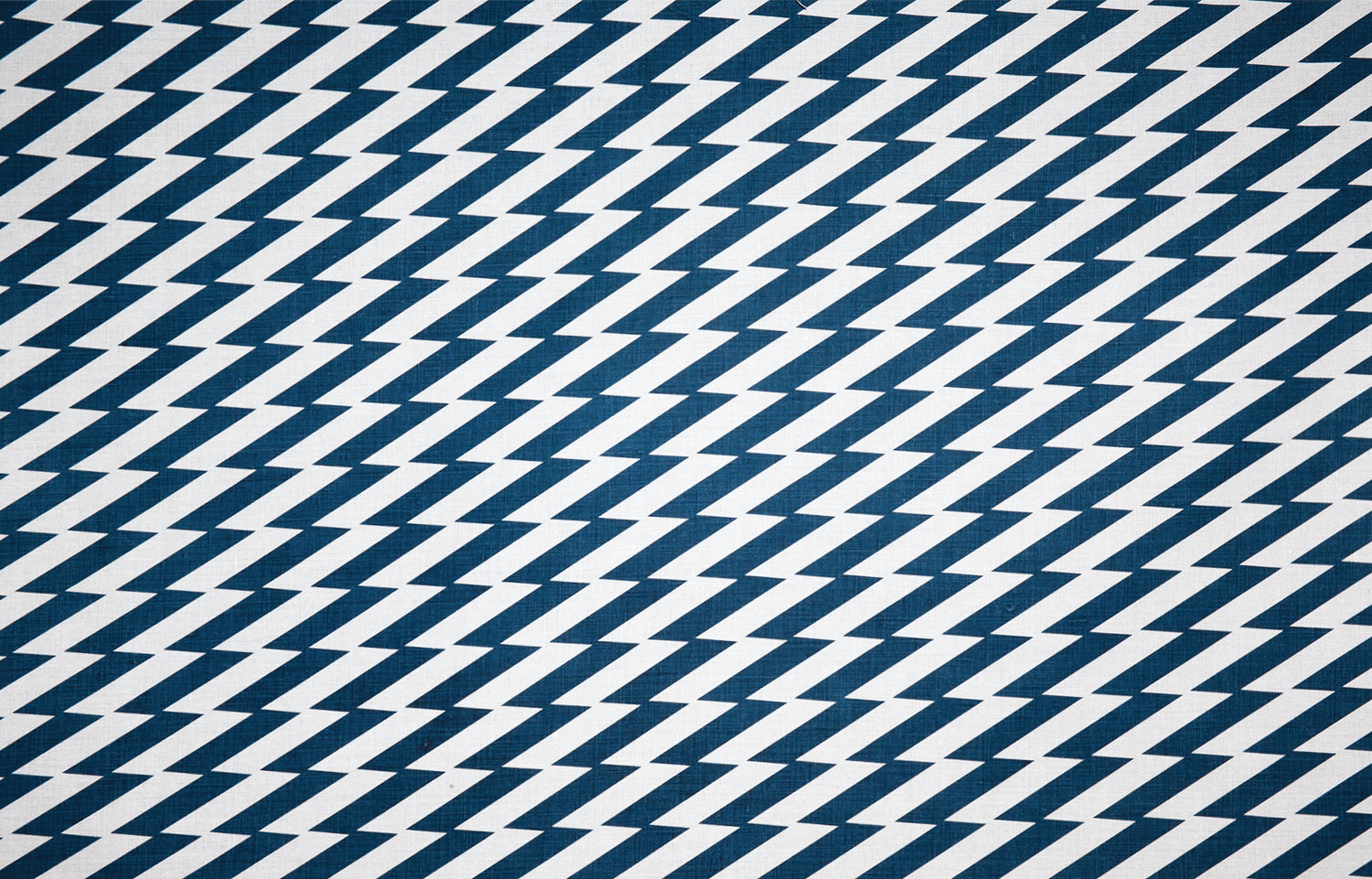 Detail of fabric in a zigzag stripe print in navy on a white field.