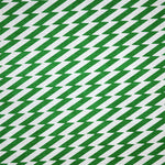Detail of fabric in a zigzag stripe print in green on a white field.