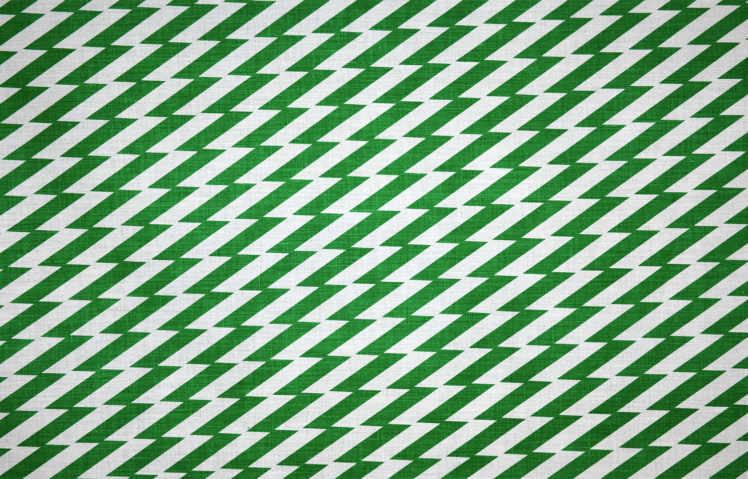Detail of fabric in a zigzag stripe print in green on a white field.