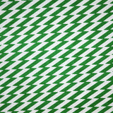 Detail of fabric in a zigzag stripe print in green on a white field.