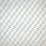 Detail of fabric in a zigzag stripe print in gray on a white field.