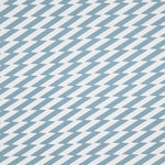 Detail of fabric in a zigzag stripe print in blue-gray on a white field.