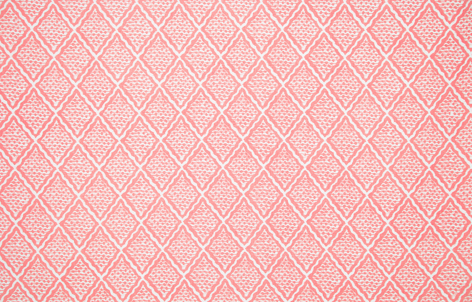 Detail of fabric in a diamond lattice print in white on a pink field.