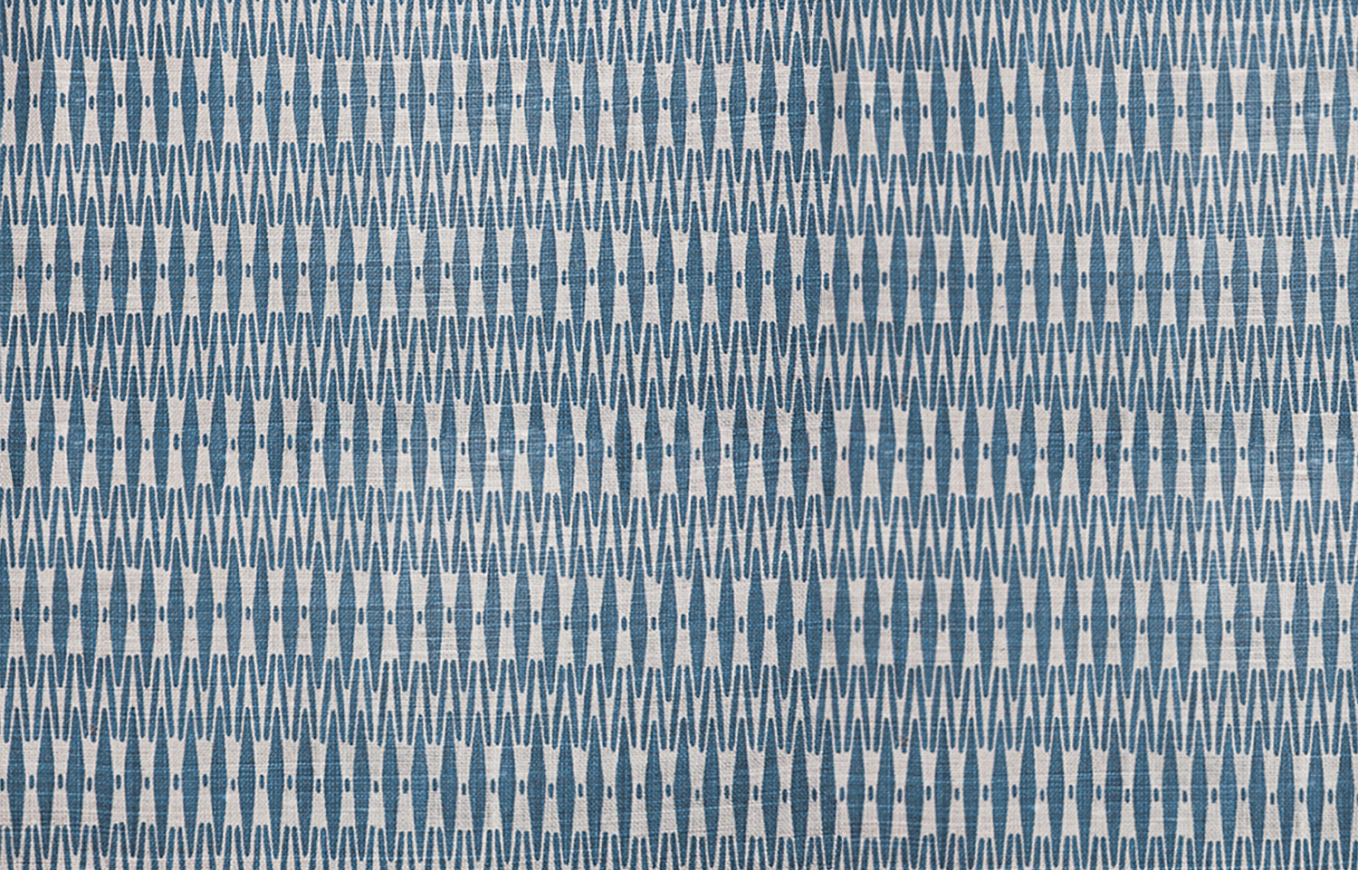 Detail of fabric in a small-scale geometric stripe print in blue and white.