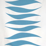 Detail of fabric in an abstract wave print in blue-gray on a white field.
