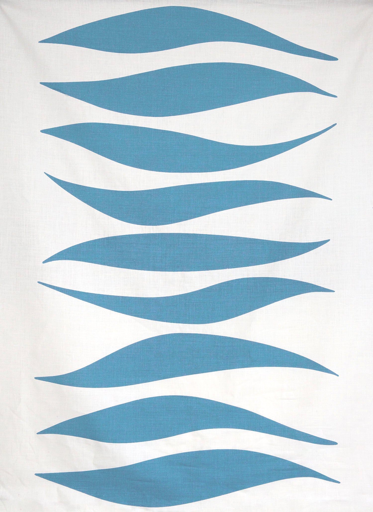 Detail of fabric in an abstract wave print in blue-gray on a white field.