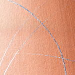 Wide-angle shot of wallpaper in an abstract curved line pattern in metallic silver on an orange field.