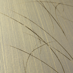 Wide-angle shot of wallpaper in an abstract curved line pattern in gold on a metallic field.