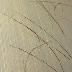 Wide-angle shot of wallpaper in an elongated paint splatter pattern in gold on a metallic field.