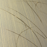 Wide-angle shot of wallpaper in an elongated paint splatter pattern in gold on a metallic field.