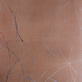 Detail of a wallpaper in an elongated paint splatter pattern in metallic navy on a rust field.