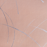Detail of a wallpaper in an abstract curved line pattern in metallic silver on a pink field.