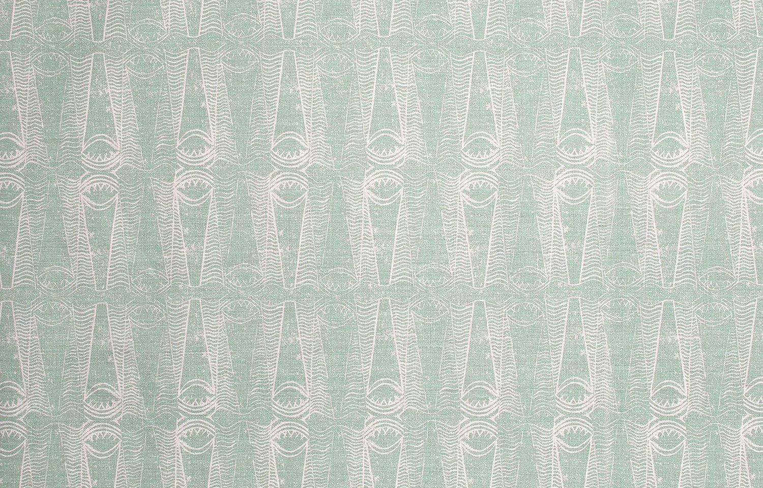 Detail of fabric in an abstract geometric print in light green and gray.