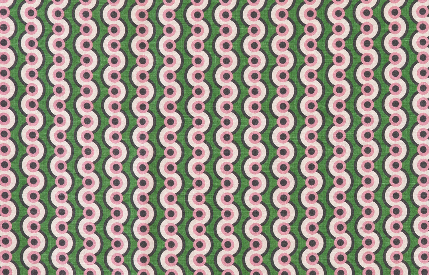 Detail of fabric in a playful curving stripe print in pink, purple and white on a green field.