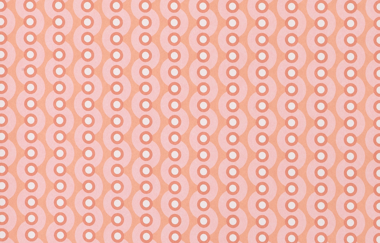Detail of wallpaper in a playful curving stripe print in pink, white and coral.