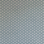 Detail of wallpaper in a minimalist quatrefoil pattern in gray on a blue field.